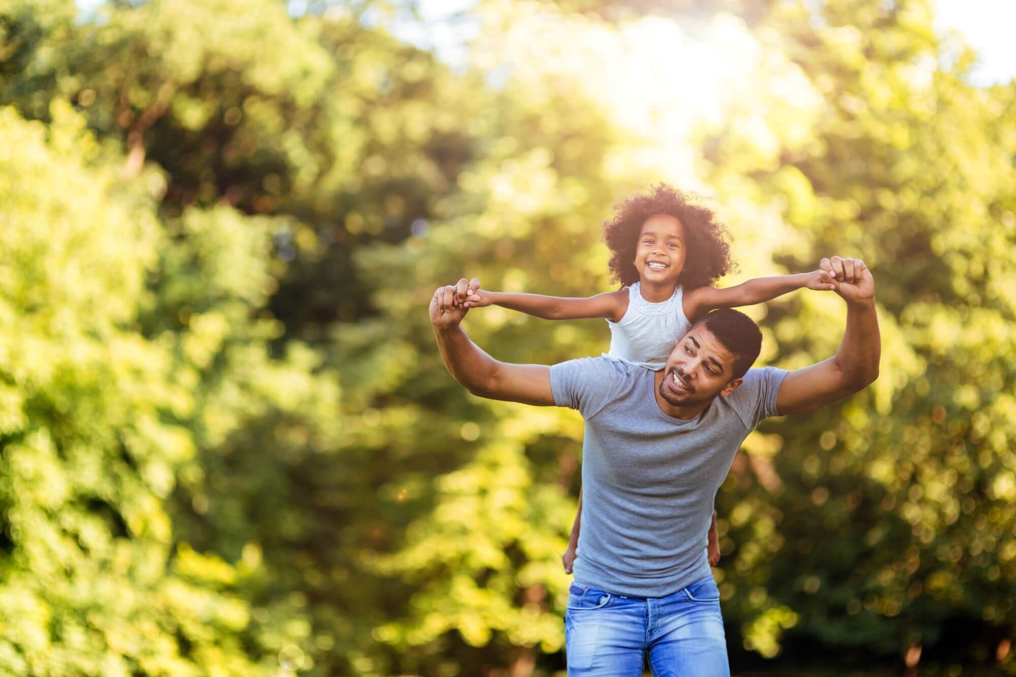 Father-carrying-his-daughter-on-his-back-image